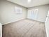 Bright and inviting bedroom with plush carpet, neutral walls, and closet space, perfect for personalization.