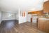 Bright open-concept living area with hardwood floors, modern kitchen, and ample natural light.