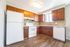 Charming kitchen with warm wooden cabinets, modern appliances, and elegant tile backsplash, offering a perfect blend of style and functionality.