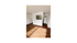 Bright apartment living space featuring elegant wood flooring, ample natural light, and a modern open kitchen layout.