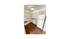 Bright and inviting kitchen with modern white cabinetry, sleek appliances, and warm wooden flooring.