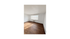 Bright and spacious room with large window and elegant hardwood flooring.