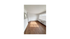 Bright, open living space with elegant wood flooring and large windows providing abundant natural light.