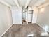 Bright and spacious bedroom with plush carpet, large closets, and elegant lighting, perfect for comfortable living.