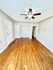 Bright and inviting living space featuring polished hardwood floors and a stylish ceiling fan, perfect for any modern home.
