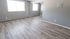 Modern apartment interior with sleek gray walls, expansive windows, and elegant hardwood flooring, perfect for a cozy and inviting atmosphere.