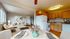 Inviting open-concept living area with modern kitchen, cozy seating, and stylish decor.