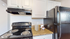 Sleek kitchen with modern black appliances, elegant white cabinets, and stylish granite countertops for a sophisticated touch.