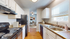 Bright and modern kitchen with sleek appliances, stylish countertops, and charming dining area view.