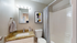 Chic bathroom featuring granite countertop, modern art, and soft ambient lighting for a serene vibe.