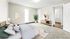Bright and cozy bedroom with plush carpeting, modern furnishings, and a serene ambiance, showcasing virtual staging.