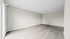 Bright and spacious empty room featuring elegant wooden flooring and large windows, perfect for customization and natural light.
