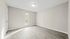 Bright, spacious living area with elegant hardwood floors and large sliding glass doors leading to a private patio.