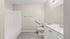 Bright, modern bathroom featuring a sleek bathtub, elegant vanity, and stylish flooring.