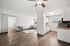 Charming open-concept apartment with warm wood flooring, inviting living area, and bright kitchen, perfect for modern living.