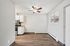 Charming open-plan kitchen and living area with modern appliances and warm wooden flooring.