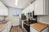 Bright and inviting kitchen with modern appliances, sleek countertops, and ample cabinet space, perfect for culinary enthusiasts.
