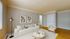 Elegant living room with a modern white sofa, stylish wooden flooring, and chic d&eacute;cor, perfect for cozy gatherings.
