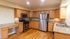 Bright and spacious kitchen featuring modern stainless steel appliances, elegant wooden cabinetry, and sleek granite countertops.