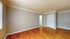 Bright and open living space with gleaming hardwood floors and neutral walls, perfect for personalization.