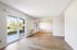 Open living area with hardwood floors and patio access at Flats on 70th at Midtown in Westminster, CO