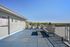 Rooftop terrace with lounge chairs and open views at Flats on 70th at Midtown in Westminster, CO