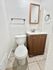 Inviting bathroom with sleek modern fixtures, elegant tile flooring, and a stylish wooden vanity.
