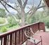 Charming balcony view with a tranquil backdrop of lush greenery and a scenic pathway, perfect for relaxation.