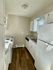 Bright and stylish kitchen with white cabinets and dark wood flooring