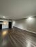 Spacious open-plan kitchen and living area with modern appliances and sleek flooring.