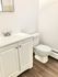 Bright, modern bathroom with white vanity and elegant fixtures.