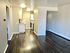 Sleek apartment interior with modern kitchen and spacious open plan living area.