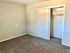 Inviting bedroom featuring plush carpet and a roomy closet with sliding doors.