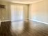 Bright living room with elegant hardwood floors and large sliding glass doors.