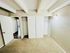 Bright bedroom with plush carpet and built-in modern closets.