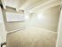 Bright and spacious bedroom featuring plush carpeting and modern wall lighting.