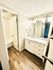 Bright bathroom with modern fixtures and elegant wood flooring.