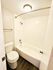 Modern bathroom featuring a sleek bathtub, stylish tiles, and efficient lighting.