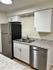 Contemporary kitchen with stainless steel appliances, dual sink, and sleek cabinetry.