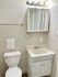 Chic bathroom with modern fixtures including a sleek vanity and bright lighting.