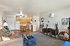Inviting living room with comfortable seating and an open-concept kitchen, featuring modern decor.