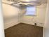Inviting room with soft carpet flooring and a large window for natural light.