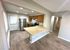 Modern kitchen with wood cabinetry, stainless steel appliances, and light countertops enhancing a spacious layout.