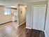 Bright apartment interior with an open layout, featuring a cozy kitchen and ample living space.