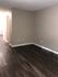 Spacious room featuring sleek hardwood flooring and neutral wall colors.