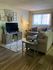 Inviting living room with stylish decor, featuring a cozy gray sectional sofa and a modern entertainment unit.