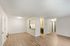 Bright open-plan living area with wooden flooring and modern kitchen.