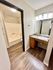 Elegant bathroom with modern sink, large mirror, and stylish bathtub with wooden flooring.