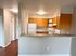 Modern kitchen with wooden cabinets, spacious countertop, and integrated appliances.