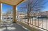 Inviting balcony overlooking a serene neighborhood, surrounded by trees and residential buildings.